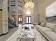 Grand foyer with high ceilings, chandelier, tile floor, and view of staircase at 3050 Wentworth Way, Tarpon Springs, FL 34688