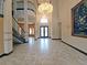 Spacious foyer with tile flooring, high ceilings, and elegant chandelier at 3050 Wentworth Way, Tarpon Springs, FL 34688