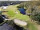 Aerial view of a serene golf course with water feature at 3050 Wentworth Way, Tarpon Springs, FL 34688