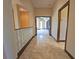 Hallway with tile flooring, glass block accent wall, and view into another room at 3050 Wentworth Way, Tarpon Springs, FL 34688