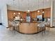 Modern kitchen with wood cabinets, granite countertops, and island with bar seating at 3050 Wentworth Way, Tarpon Springs, FL 34688