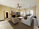 Living room with fireplace, ceiling fan, and large windows at 3050 Wentworth Way, Tarpon Springs, FL 34688