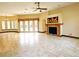Spacious living room featuring a fireplace, large windows, and tile flooring at 3050 Wentworth Way, Tarpon Springs, FL 34688