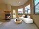 Main bedroom sitting area with fireplace, large windows, and access to a balcony at 3050 Wentworth Way, Tarpon Springs, FL 34688