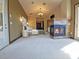 Main bedroom with a fireplace, carpeted floors, and a bed at 3050 Wentworth Way, Tarpon Springs, FL 34688