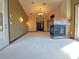 Spacious main bedroom with a fireplace and carpeted floors at 3050 Wentworth Way, Tarpon Springs, FL 34688