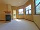 Spacious main bedroom with a fireplace and large windows at 3050 Wentworth Way, Tarpon Springs, FL 34688