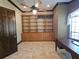 Office with built-in shelving and wood desk at 3050 Wentworth Way, Tarpon Springs, FL 34688