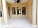 Covered patio with ceiling fan, columns, and view of the pool at 3050 Wentworth Way, Tarpon Springs, FL 34688