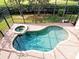Inviting freeform pool and spa with brick pavers at 3050 Wentworth Way, Tarpon Springs, FL 34688