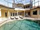 Private pool with lounge chairs and surrounding columns at 3050 Wentworth Way, Tarpon Springs, FL 34688