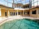 Inviting pool area with a covered patio and lush landscaping at 3050 Wentworth Way, Tarpon Springs, FL 34688