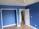 Blue bedroom with wood flooring and ceiling fan at 3346 Foxridge Cir, Tampa, FL 33618