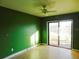 Bedroom with green walls and sliding glass doors at 3346 Foxridge Cir, Tampa, FL 33618