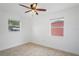 Spacious bedroom with two windows and ceiling fan at 3414 W Louisiana Ave, Tampa, FL 33614