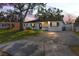 Modern house exterior with a driveway and landscaping at 3414 W Louisiana Ave, Tampa, FL 33614