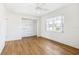 Hardwood floor bedroom with a ceiling fan and large closet at 3743 Overlook Ne Dr, St Petersburg, FL 33703