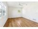 Sunny bedroom with hardwood floors and a ceiling fan at 3743 Overlook Ne Dr, St Petersburg, FL 33703