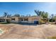 Tan single-story house with a circular driveway, attached garage, and mature landscaping at 448 55Th Ne Ave, St Petersburg, FL 33703