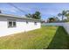 Large backyard with grassy lawn and white vinyl fence at 4501 Helena Ne St, St Petersburg, FL 33703