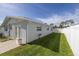 Grass lawn, white fence, and home exterior view at 4501 Helena Ne St, St Petersburg, FL 33703