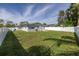 Large backyard with grassy area and a white fence at 4501 Helena Ne St, St Petersburg, FL 33703