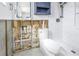 Bathroom under renovation, features a toilet and shower with marble-style wall tiles at 4501 Helena Ne St, St Petersburg, FL 33703