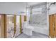 Renovation in progress, showcasing a toilet and bathtub with marble-style tile at 4501 Helena Ne St, St Petersburg, FL 33703