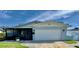 Charming single-story home with a white exterior, attached garage, and a well-maintained lawn at 4501 Helena Ne St, St Petersburg, FL 33703