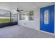 Inviting front porch with tiled floor, ceiling fan, and bright blue door at 4501 Helena Ne St, St Petersburg, FL 33703