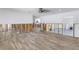 Renovation in progress, living room with new flooring and exposed framing at 4501 Helena Ne St, St Petersburg, FL 33703