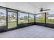 Spacious screened porch with tiled floor and ceiling fan at 4501 Helena Ne St, St Petersburg, FL 33703