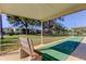 Shuffleboard court with a shaded bench, perfect for outdoor recreation at 5085 1St Ne St # 143, St Petersburg, FL 33701