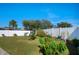 Landscaped backyard with lush lawn and white fence at 528 Painted Leaf Dr, Brooksville, FL 34604