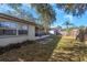 Spacious backyard with screened patio, shed, and wooden fence at 5653 Mariposa Dr, Holiday, FL 34690