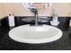 Bathroom with round sink and black countertop at 5729 Puerta Del Sol S Blvd # 477, St Petersburg, FL 33715