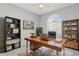 Bright home office features built-in shelving and a large desk at 5912 Willow Creek Ct, New Port Richey, FL 34655