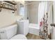 Cozy bathroom with a tub and shower combo, white vanity, and decorative shelves for extra storage at 6366 38Th N Ave, St Petersburg, FL 33710