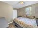 Spacious bedroom with floral bedding and ceiling fan at 6366 38Th N Ave, St Petersburg, FL 33710