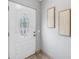 Bright entryway featuring a decorative glass front door, neutral wall decor, and tiled flooring for a welcoming ambiance at 6366 38Th N Ave, St Petersburg, FL 33710