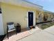Close-up of the front of the home, showing the seating, blue door and landscaping at 6366 38Th N Ave, St Petersburg, FL 33710