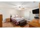 Cozy bedroom with wood-look floors and a ceiling fan at 6411 Sunhigh Dr, New Port Richey, FL 34655