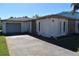 House exterior with stone accents and a driveway at 7028 Southwind Dr, Hudson, FL 34667