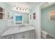 Updated bathroom with gray vanity and marble countertop at 7108 Riverwood Blvd, Tampa, FL 33615