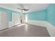 Bedroom with white wainscoting, ceiling fan and updated flooring at 7108 Riverwood Blvd, Tampa, FL 33615