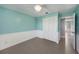 Bedroom with white closet doors and light teal walls at 7108 Riverwood Blvd, Tampa, FL 33615