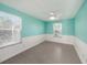 Bedroom with ceiling fan and updated flooring at 7108 Riverwood Blvd, Tampa, FL 33615