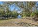 Peaceful backyard oasis with a scenic view of a canal and outdoor seating at 7108 Riverwood Blvd, Tampa, FL 33615