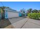White garage door and light blue exterior wall of the house at 7108 Riverwood Blvd, Tampa, FL 33615