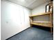 Garage storage area with pegboard and wooden shelves at 7108 Riverwood Blvd, Tampa, FL 33615
